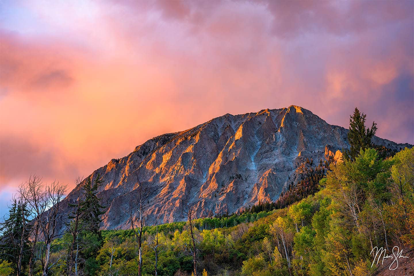 A vivid sunset lights up Marcellina Mountain in a blaze of glory near Kebler Pass, Colorado.