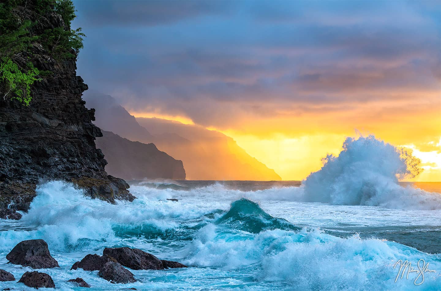 A massive wave crashes in the rocks below the Napali Coast of Kauai