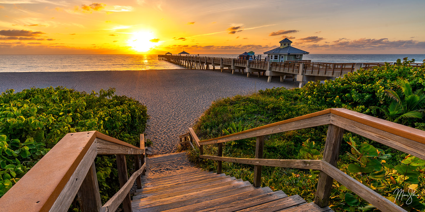 A beautiful sunrise over Juno Beach Pier in Jupiter, Florida